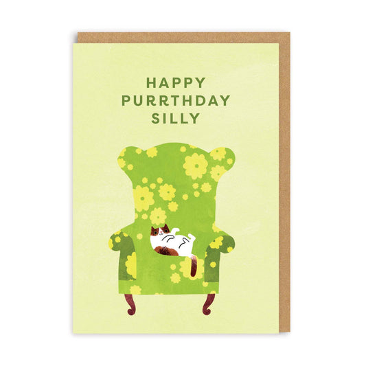 Green Birthday card with a cat on an armchair and text that reads Happy Purrthday Silly