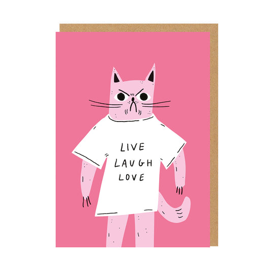 Pink greeting card with a grumpy cat wearing a t-shirt with the text Live Laugh Love