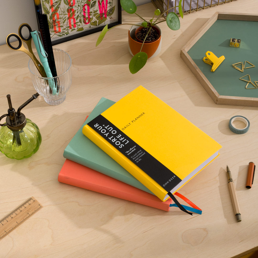 A Stack of daily planners and organisers on a desk