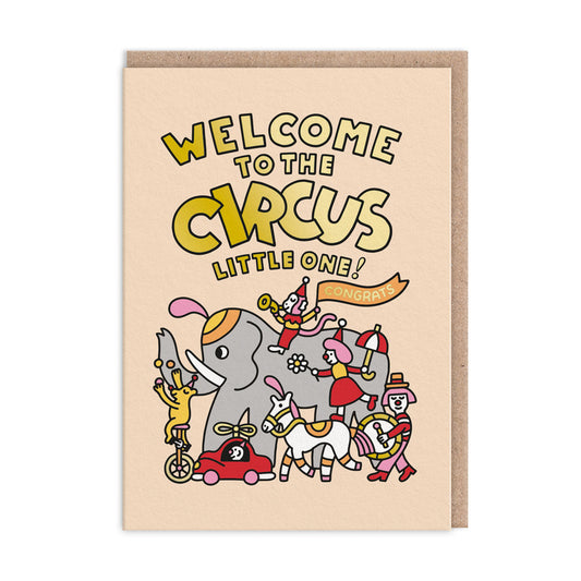 Cute New Baby Card. Featuring a cartoon illustration of a circus and animals with gold foil text that reads "Welcome To The Circus Little One"